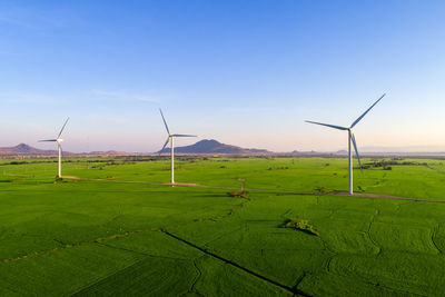 Windmill on field against sky