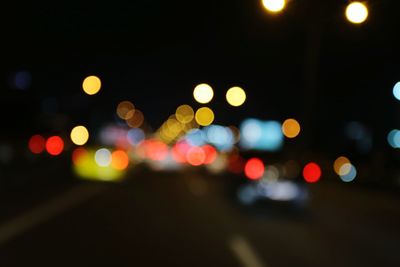 Defocused image of illuminated street lights at night