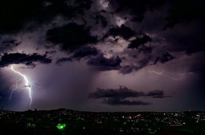 Lightning in sky over city at night