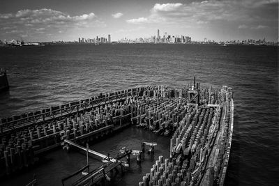 Aerial view of pier on sea against buildings