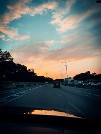 Road against sky seen through car windshield