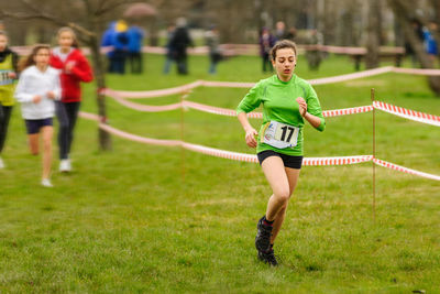 Athlete running at grassy field