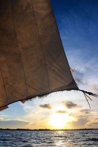 Low angle view of sea against sky during sunset