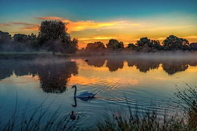 Scenic view of lake against sky during sunset