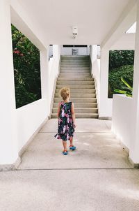 Rear view of woman walking on staircase
