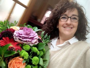 Portrait of smiling woman with flower bouquet