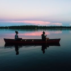 Silhouette of man looking at lake