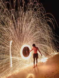 Man spinning wire wool at night long exposure