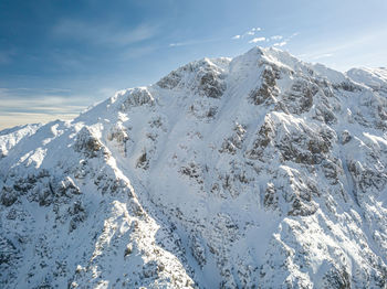 Scenic view of snow covered mountains against sky