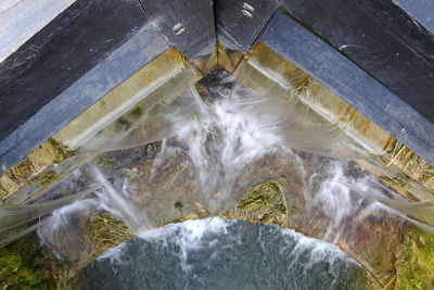 High angle view of water squirting out from  closed lock gate