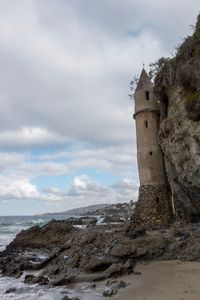 View of lighthouse against cloudy sky