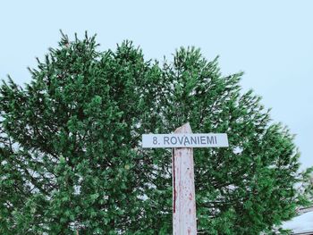 Low angle view of road sign against trees