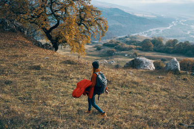 Rear view of woman walking on mountain