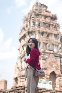 Portrait of young woman standing in temple