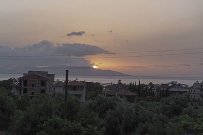 Scenic view of buildings against sky during sunset