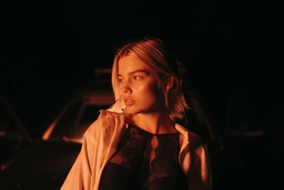 Night portrait of a woman near the car