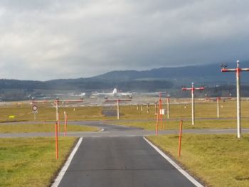 Empty road against cloudy sky