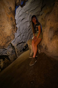 Portrait of woman sitting on rock