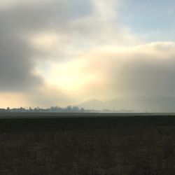 Scenic view of field against sky during sunset