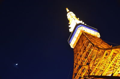 Low angle view of illuminated tower against clear sky