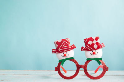 Close-up of christmas decoration on table against blue background