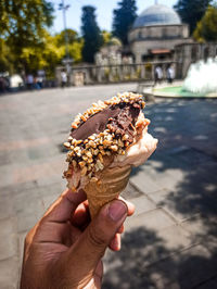 Cropped hand of woman holding ice cream cone