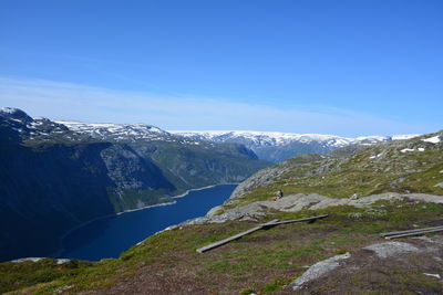 Scenic view of mountains against clear blue sky