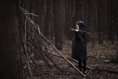 Full length of person standing in forest