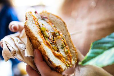 Cropped hand of person holding food