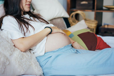 Close-up of belly of a pregnant woman on the eighth month in the third trimester. 