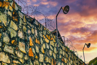 Low angle view of street light against sky at sunset