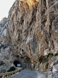 Road amidst rocky mountains against sky