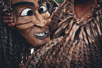 Midsection of person wearing costume and holding mask