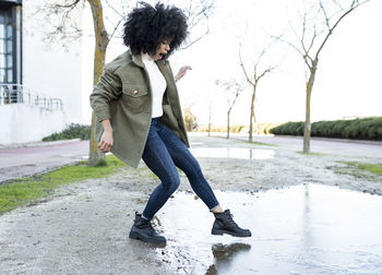 Full length of woman on footpath during winter