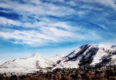 Scenic view of snowcapped mountains against sky