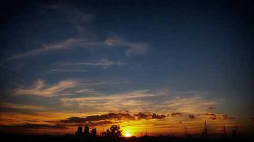 Scenic view of silhouette trees against sky at sunset