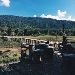 Chairs on landscape against mountains