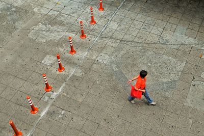 High angle view of boy playing with umbrella
