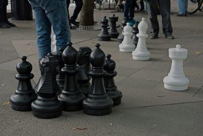Low section of man standing on chess board