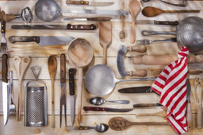 Various kitchen utensils hanging on wood