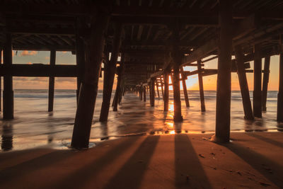 Low angle view of bridge at calm sea