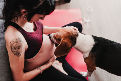 Pregnant woman with dog sitting at home