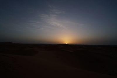 Scenic view of desert against sky during sunset