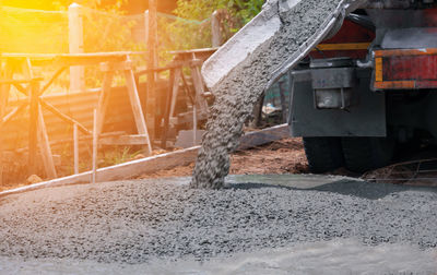 Low section of man standing on road