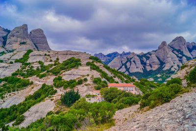 Scenic view of mountain against cloudy sky