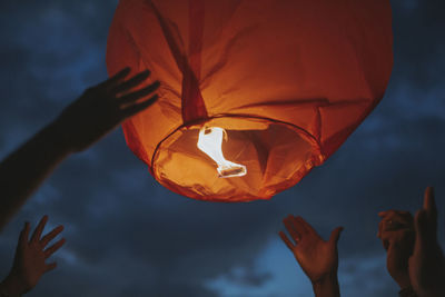 People celebrating a fire lantern festival  setting off fire lanterns.