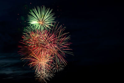 Low angle view of firework display at night