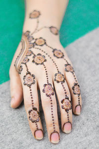 Close-up of woman with henna tattoo