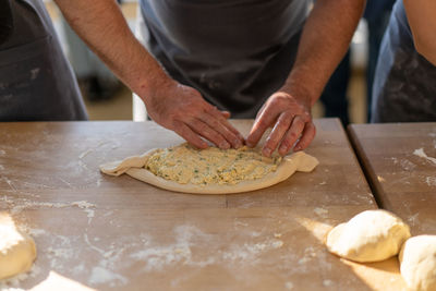 Midsection of man preparing food