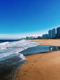 View of beach against blue sky